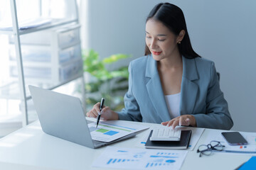 young beautiful businesswoman working in the office use a notebook and laptop.
