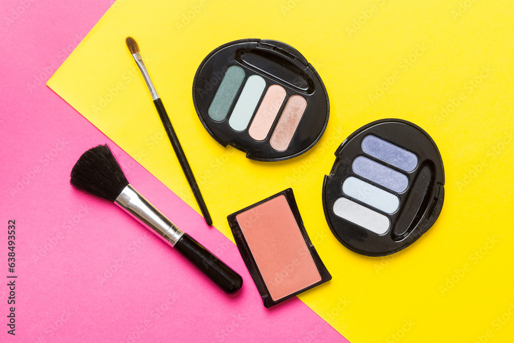 Wall mural Professional makeup tools. Top view. Flat lay. Beauty, decorative cosmetics. Makeup brushes set and color eyeshadow palette on table background. Minimalistic style