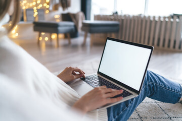 Crop female freelancer working remotely from home on computer