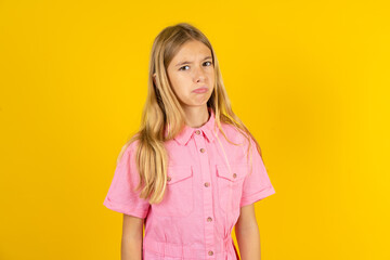Obraz premium Beautiful caucasian kid girl wearing pink shirt depressed and worry for distress, crying angry and afraid. Sad expression.