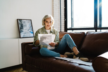 Female writer creating story on sofa