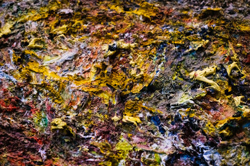 Detail of the brushstrokes with dry paint of many colors, art and its forms in the material.
