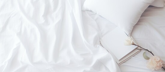 White bedding on the bed with a notepad and interior design mockup