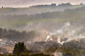 dymiące kominy wioski w zimny jesienny dzień w Beskidach