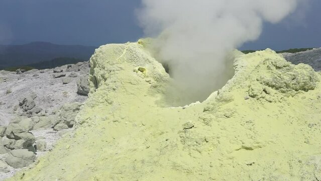 smoking solfatara in a fumarole field on the slope of the Mendeleev volcano
