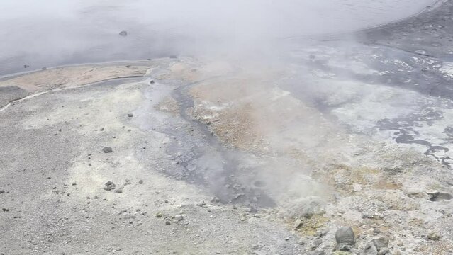 steaming hydrothermal outlet on the shore of the hot lake in the caldera of the Golovnin volcano on the island of Kunashir