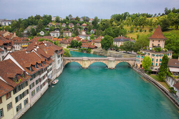 Fototapeta na wymiar View of Old Town and the emerald-colored Aare River in Bern, the capital of Switzerland 