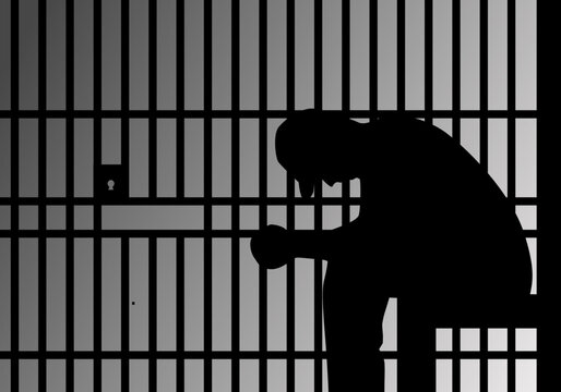 silhouette of a prisoner behind bars