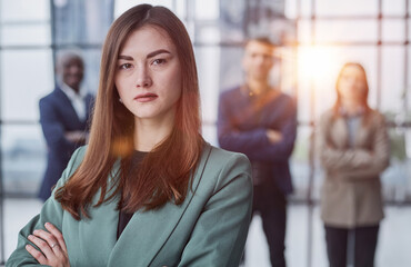 Portrait of a confident young businesswoman standing with her arms crossed in an office