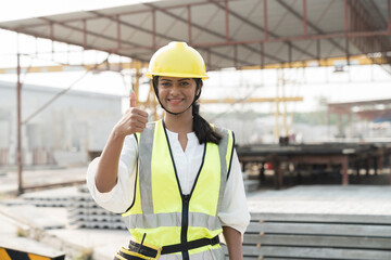 Portrait of female construction worker at construction site. Asian woman construction worker...