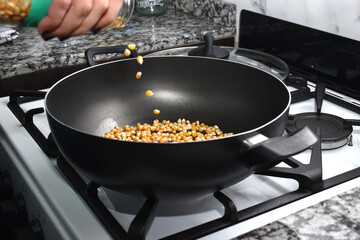 woman cooking popcorn at home to watch a movie