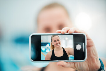 Phone, selfie or happy woman after a swimming exercise, training or workout with photograph. Relax, screen or hand of excited female swimmer taking a picture to post on mobile app on fitness break