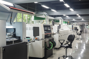 workshop with production line for printed circuit board, automatic chip mounter
