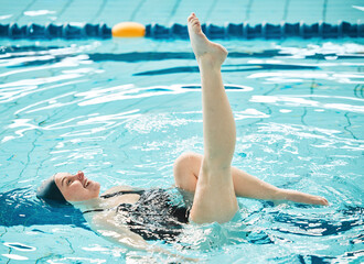 Swimming, woman and legs in ballet exercise, training and healthy body wellness in water. Pool,...