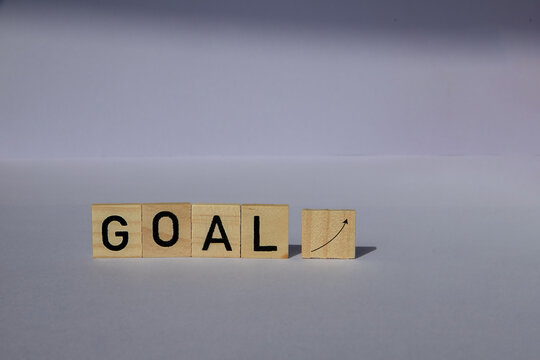 The concept of the beginning of the new year. wooden blocks with the phrase Goal on purple background