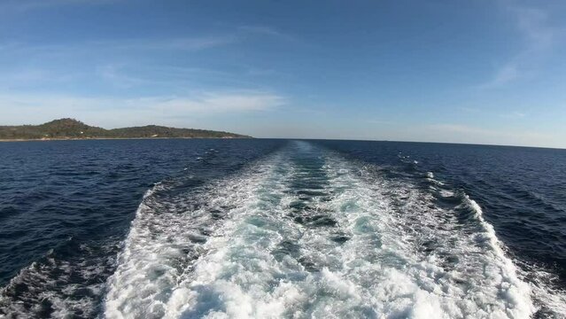 Tranquil voyage: Ship's wake reveals sea vistas & island charm as it sails. Mesmerizing maritime journey