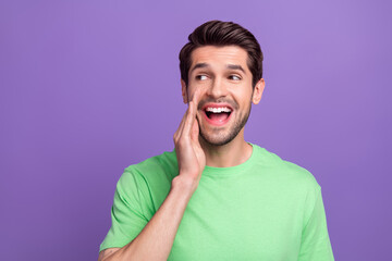 Portrait of pleasant good mood guy with bristle wear green t-shirt look empty space announcing sale...