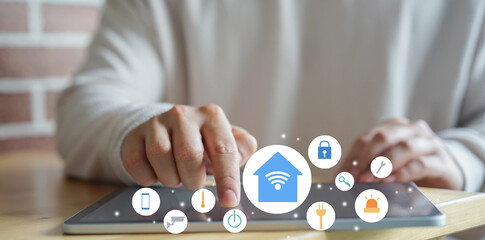 close up man use digital tablet for turn on wifi technology for using home automation function to looking inside or outside home and property , ai innovation future concept