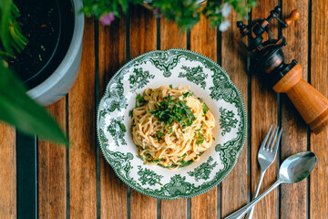 Delicious Italian Pasta Dish with Bacon and Carbonara Sauce on a Wooden Table