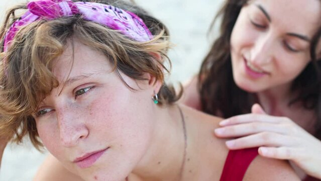 Happy caucasian lesbian couple touching each other with a smile and warmth. The best partner hugs. Relationship concept of LGBTQ couple who spend time together.