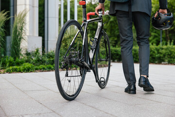 Man in a suit with a bike in the office area
