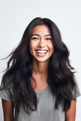 Fototapeta premium woman smiling against a white background in studio shot