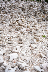 Small stone pyramides near alpine lake Braies or Pragser Wildsee, Dolomites Alps, Italy.