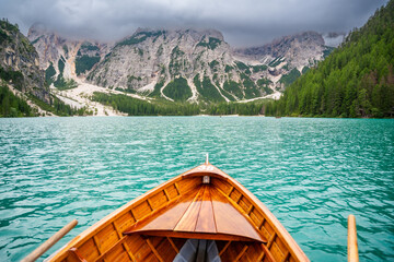 Traditional wooden rowing boat on scenic Lago di Braies in the Dolomites, South Tyrol, Italy