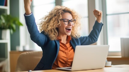 Successful entrepreneur celebrating with fist pump in front of laptop.  - obrazy, fototapety, plakaty