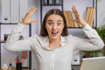 Excited amazed Caucasian business woman freelancer looking shocked surprised wow showing hands...