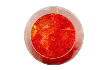 Sweet fruit jelly dessert in a glass isolated on a white background.
