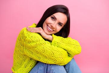 Photo of dreamy lovely lady wear knitted yellow sweater sitting floor relax rest good mood isolated on pink color background