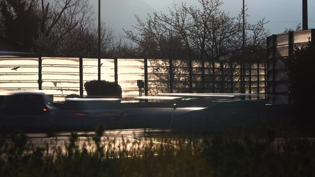 Time Lapse of Traffic Rush Hour in a roundabout at morning sun counter light - Nova Gorica, Slovenia, Erope

