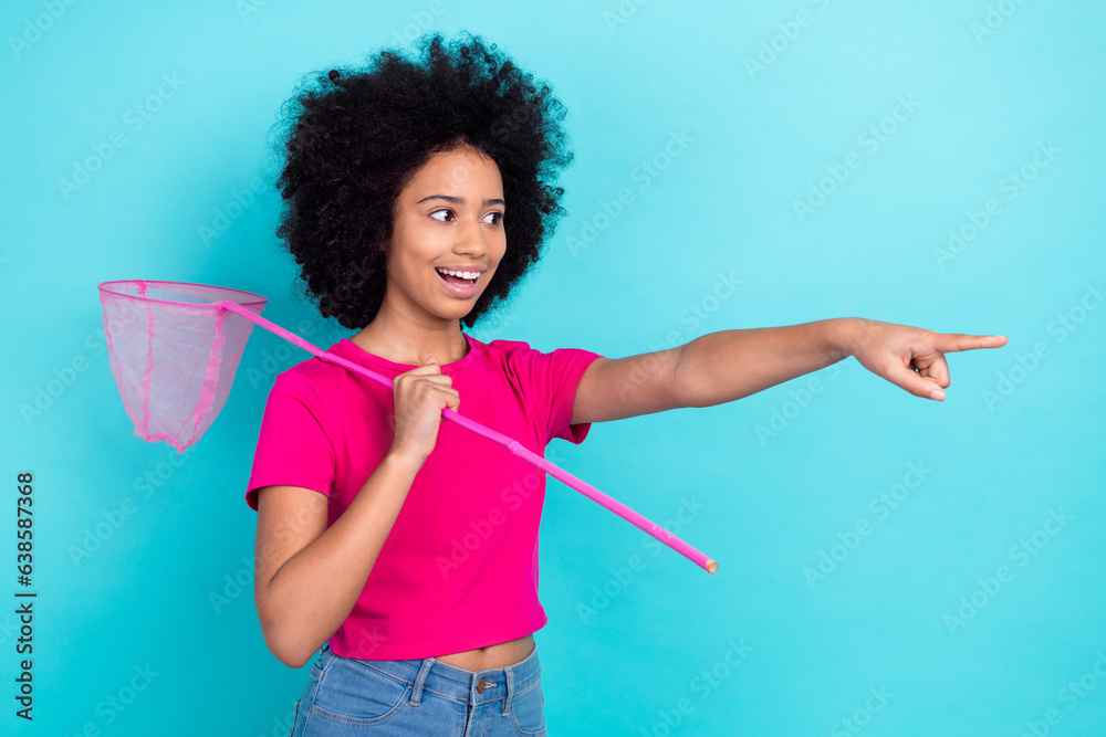 Sticker photo of good mood girl with afro chevelure wear pink t-shirt hold fishnet directing look empty spac