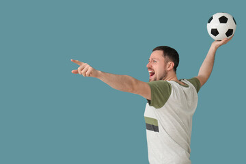 Screaming man with soccer ball on blue background