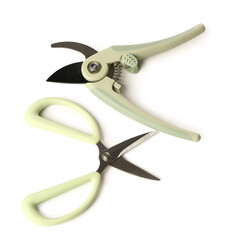 Floral scissors and secateurs with green handle on white background