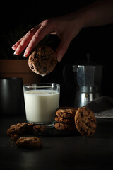 A glass with milk and chocolate cookies