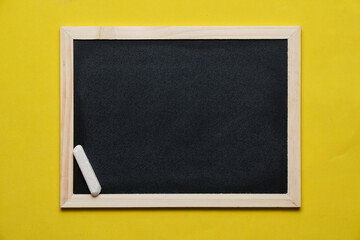 Chalkboard with chalk on bright yellow background.