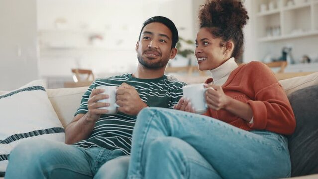 Couple, watching tv and talk with coffee on sofa, relax and streaming subscription in home living room. Man, woman and smile with movie, video and chat on couch for matcha, coco or latte in lounge