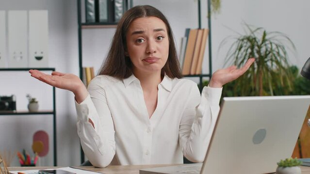 I dont know what to say. Confused business woman works on laptop at office workplace. Freelancer feeling embarrassed about ambiguous question, having doubts, no answer idea, being clueless, uncertain