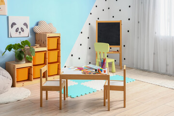 Interior of children's room with art supplies on table