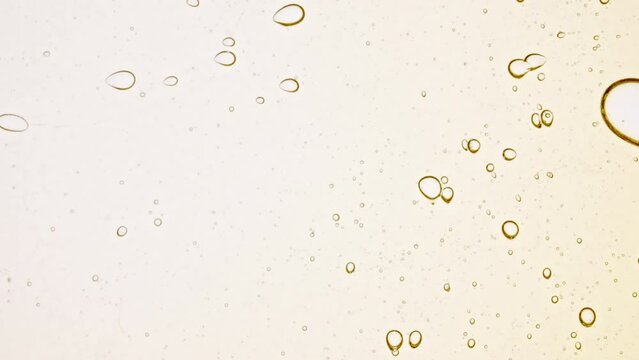 Transparent cosmetic gel fluid with molecule bubbles oil distribution. Bubble cluster, cells under a microscope. Macro Shot of Natural Organic Cosmetics, Medicine. Production Close-up. Slow Motion. 4k