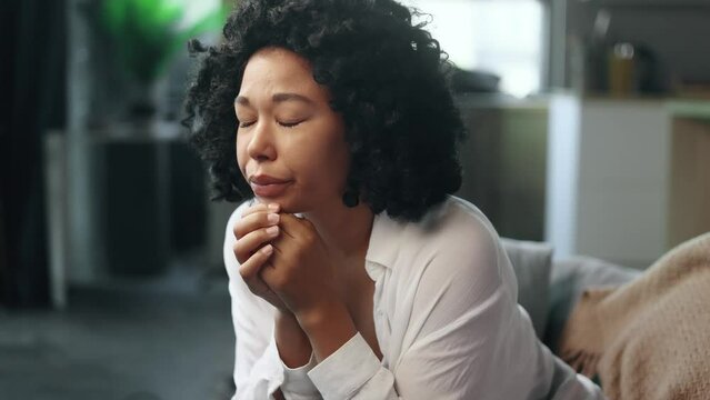 Close up portrait of crying sad young curly woman suffering from depression anxiety loneliness or mental health problem at home Head shot of brunette female upset feeling stress and pressure indoors
