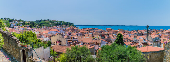Naklejka na ściany i meble A panorama view from the base of the cathedral above the town of Piran, Slovenia in summertime