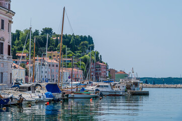 Fototapeta na wymiar A view along the side of the inner harbour towards the town of Piran, Slovenia in summertime