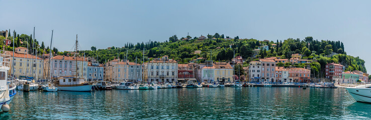 Fototapeta na wymiar A panorama view across the outer harbour towards the town of Piran, Slovenia in summertime
