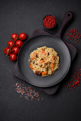 Delicious Uzbek pilaf with chicken, carrots, barberry, spices and herbs