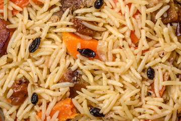 Delicious Uzbek pilaf with chicken, carrots, barberry, spices and herbs