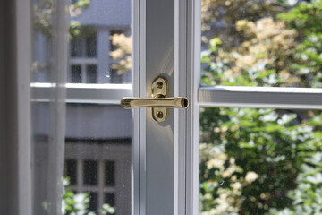 Detail of a window handle on the window of an old apartment building