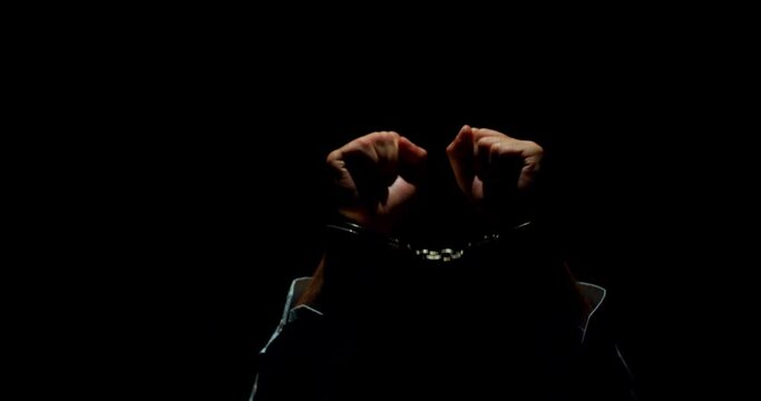 Shrouded Guilt. The Haunting Desperation of a Handcuffed Businessman, Clad in Darkness, Conveying a Raw Mix of Sin, Innocence, and Utter Hopelessness.
